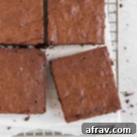 Fudgy oat flour brownies cut into squares on a wire cooling rack.