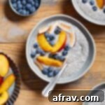A vibrant bowl of Oat Milk Chia Pudding, beautifully topped with fresh nectarine slices and blueberries, ready to be enjoyed as a healthy and creamy breakfast.