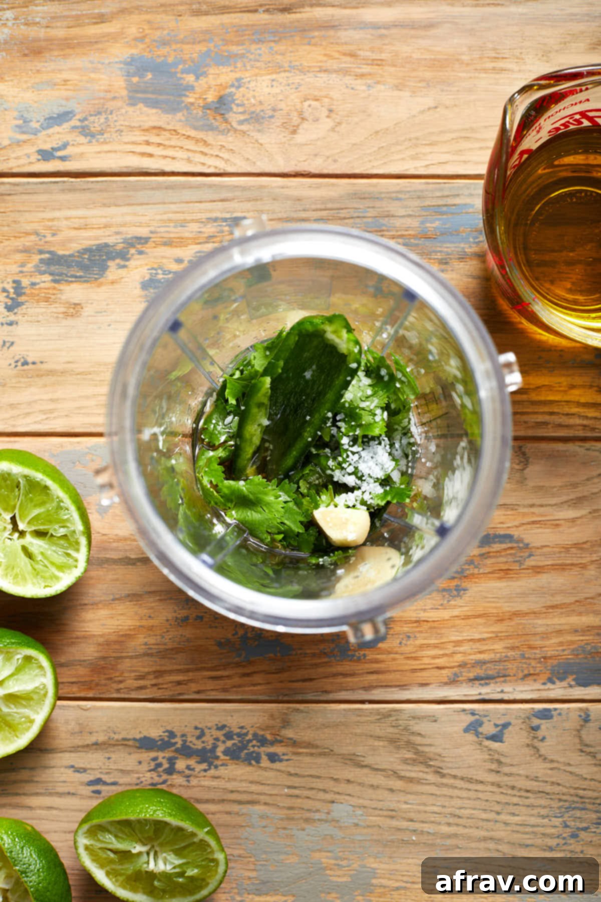Overhead view of vinaigrette ingredients in a blender cup.