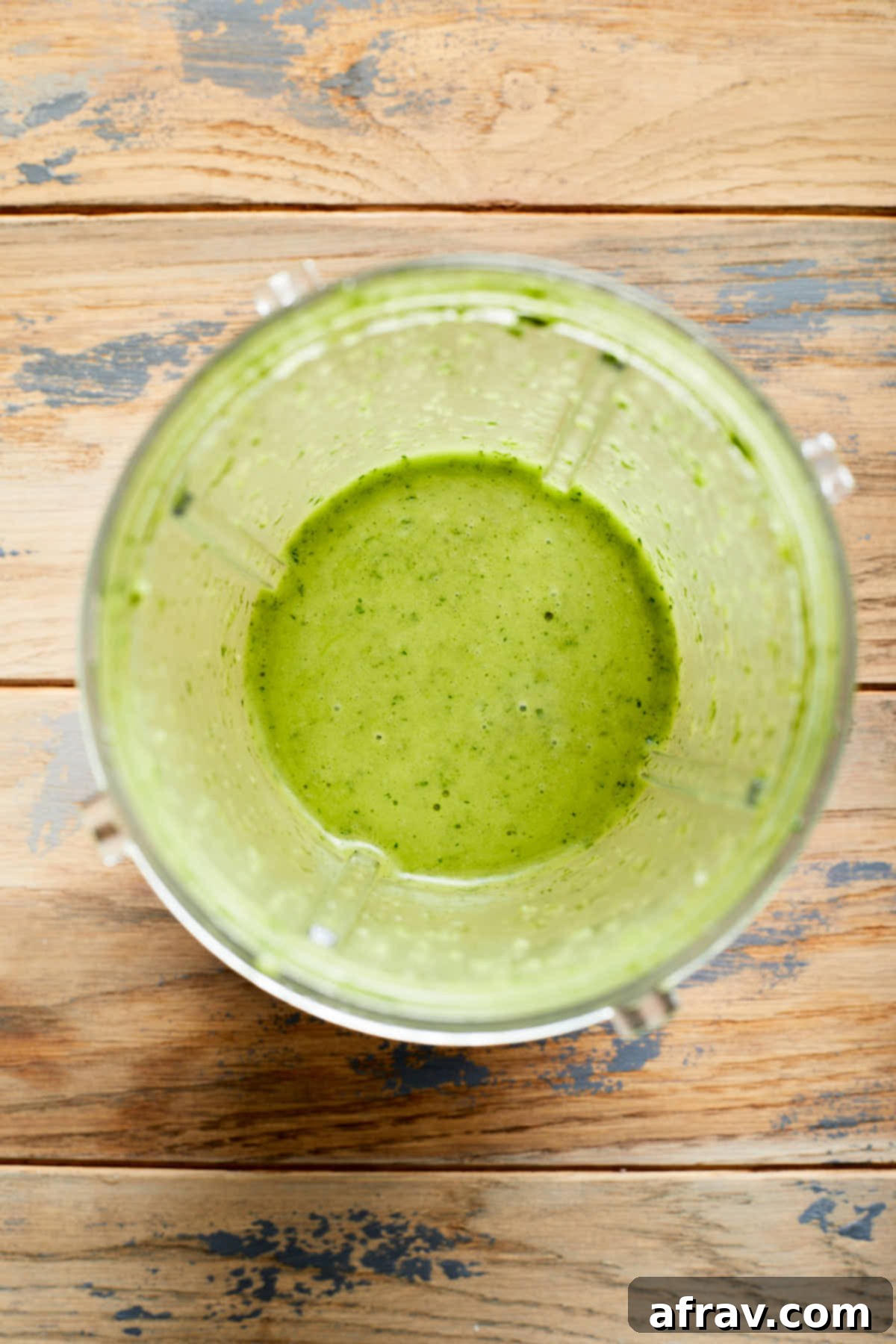 Overhead view of blended vinaigrette in a blender cup.