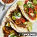 Zesty Ground Beef Fajitas 8 Ground beef fajitas with toppings arranged on a platter.