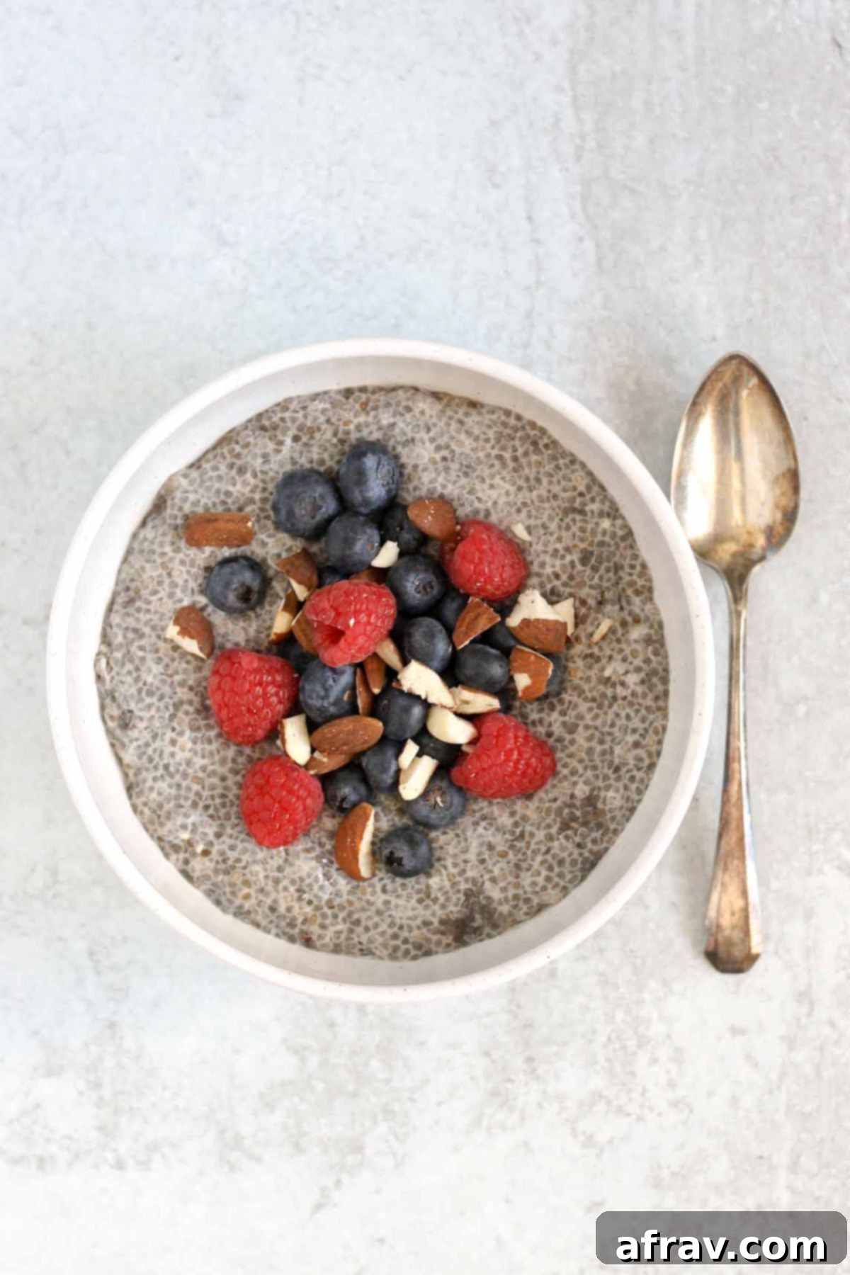 Chia breakfast bowl topped with fresh berries and almonds.