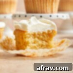 Side view of half an almond flour cupcake on a cupcake liner.