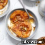 Sweet Air-Fried Pears 8 Air fryer pear halves in a blue bowl with yogurt and granola.