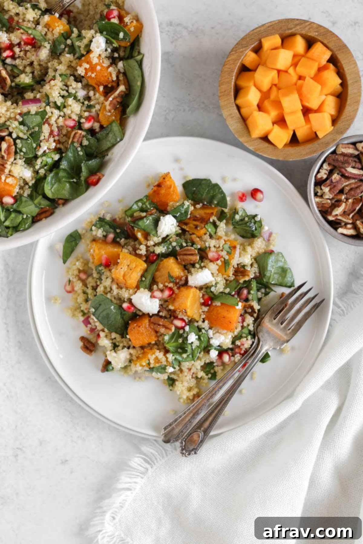 Harvest Quinoa Power Bowl 11 Single serving of fall quinoa salad with roasted butternut squash on a small white plate with 2 vintage forks.