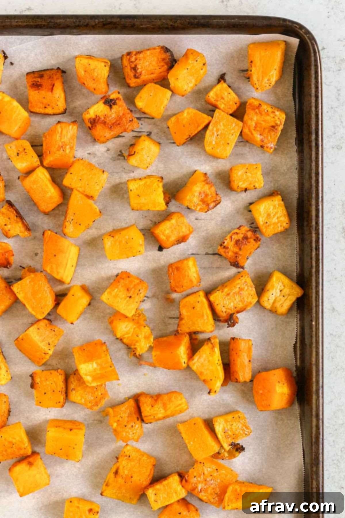 Harvest Quinoa Power Bowl 4 Roasted butternut squash cubes on a baking sheet.