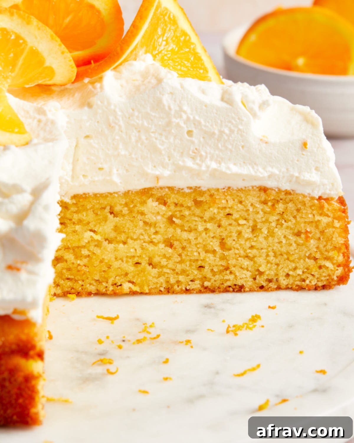 Orange Zest Almond Cake 8 Close up view of the texture of the cake and whipped cream topping.
