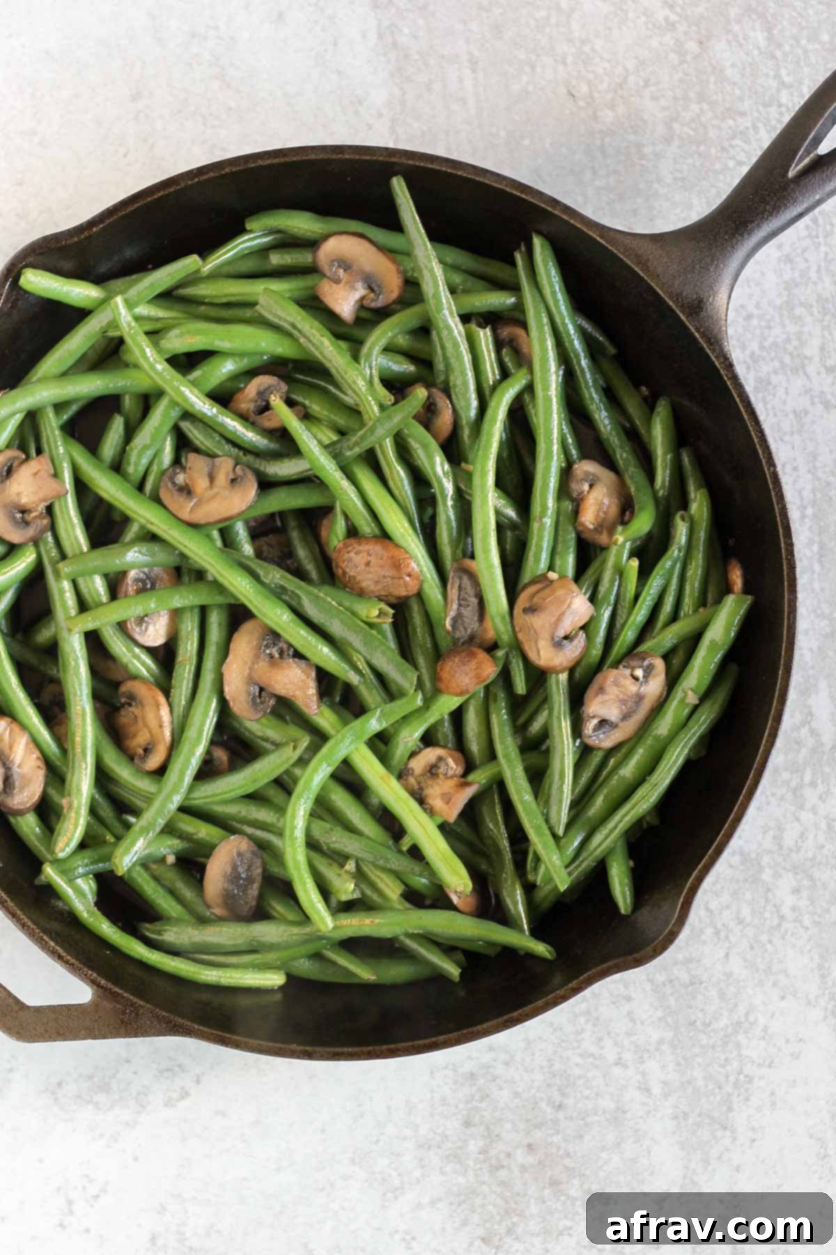 Savory Skillet Green Beans with Onions and Mushrooms 6 Green beans and mushrooms in a cast iron skillet.