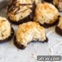 Coconut macaroon cookie with a bite taken out of it.