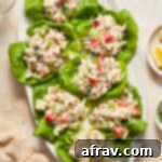 Tuna salad lettuce wraps arranged on a white oval platter.