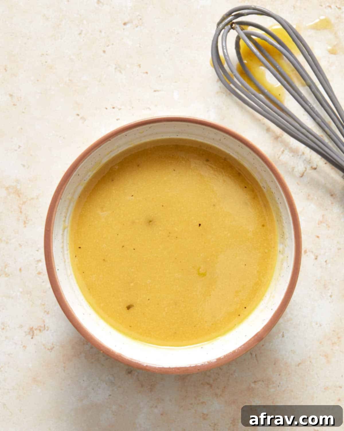 Dijon mustard dressing in a small bowl.