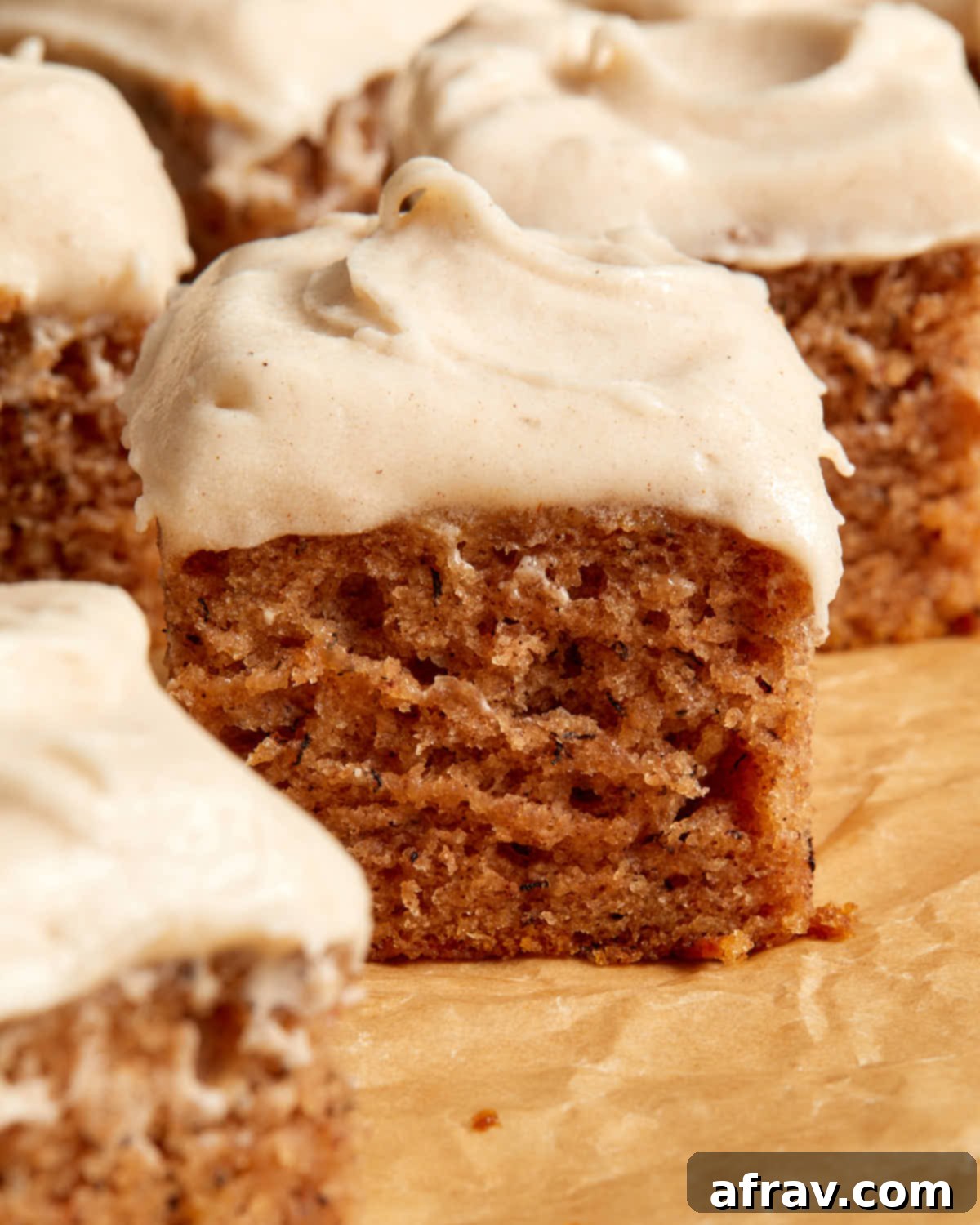 Side view of pieces of banana cake topped with frosting.