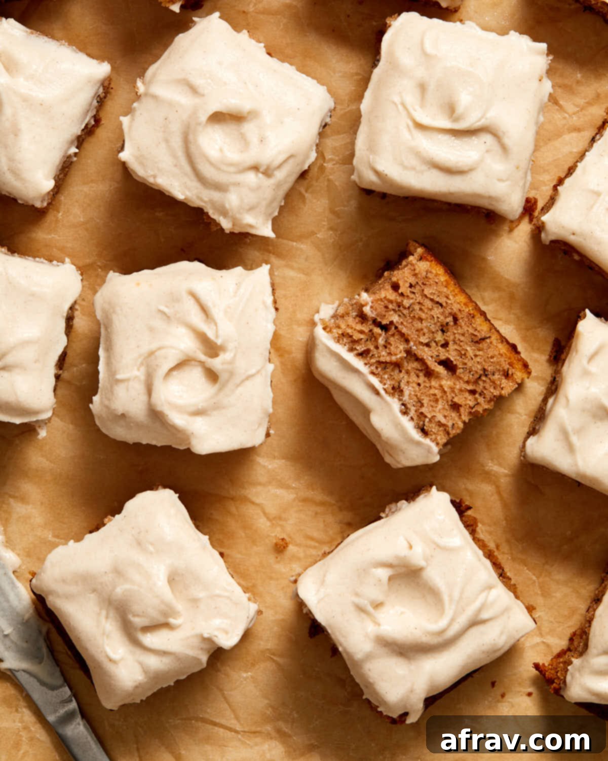 Overhead view of pieces of banana cake arranged on brown parchment paper.