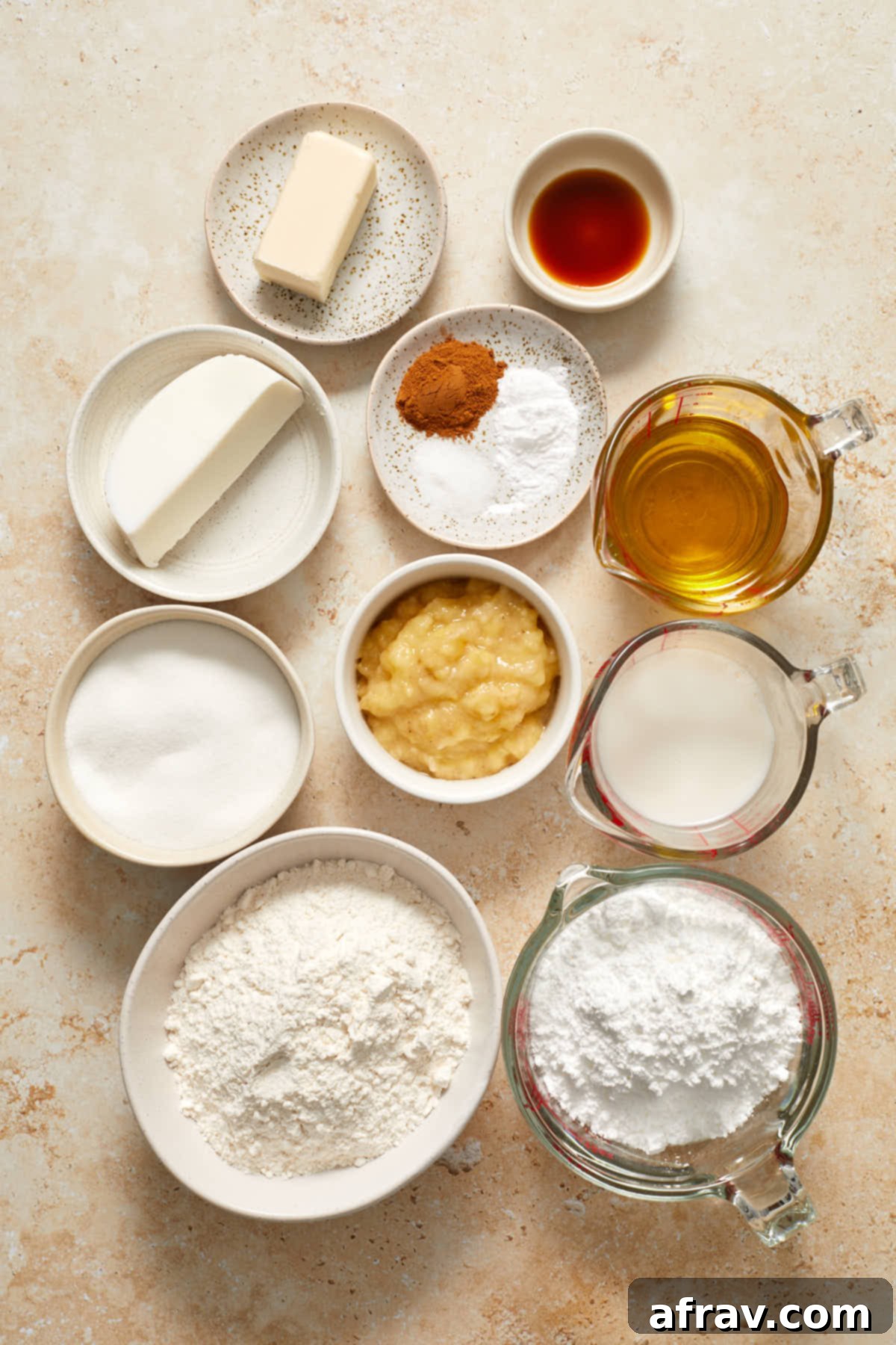 Ingredients to make banana cake and cream cheese frosting arranged individually.