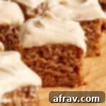Close up view of a piece of banana cake topped with cinnamon cream cheese frosting.