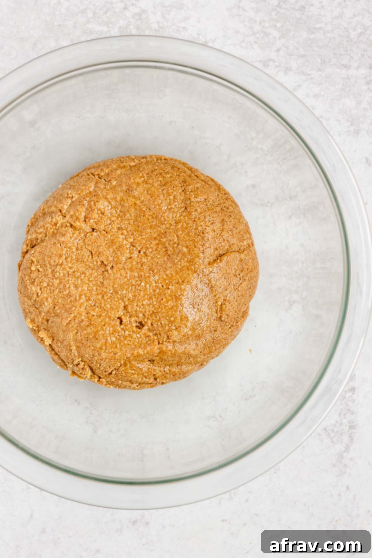The perfectly mixed peanut butter dough in a glass bowl, ready for chilling.