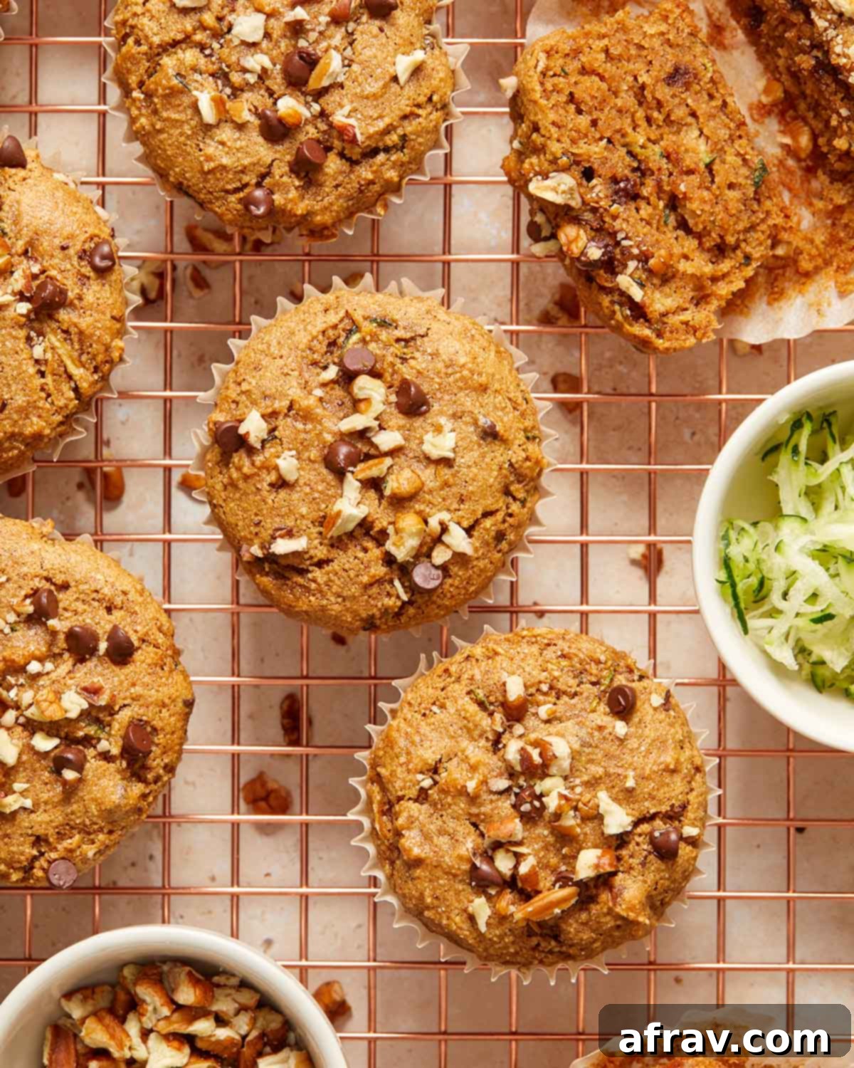 Zucchini muffins arranged on a wire cooling rack.