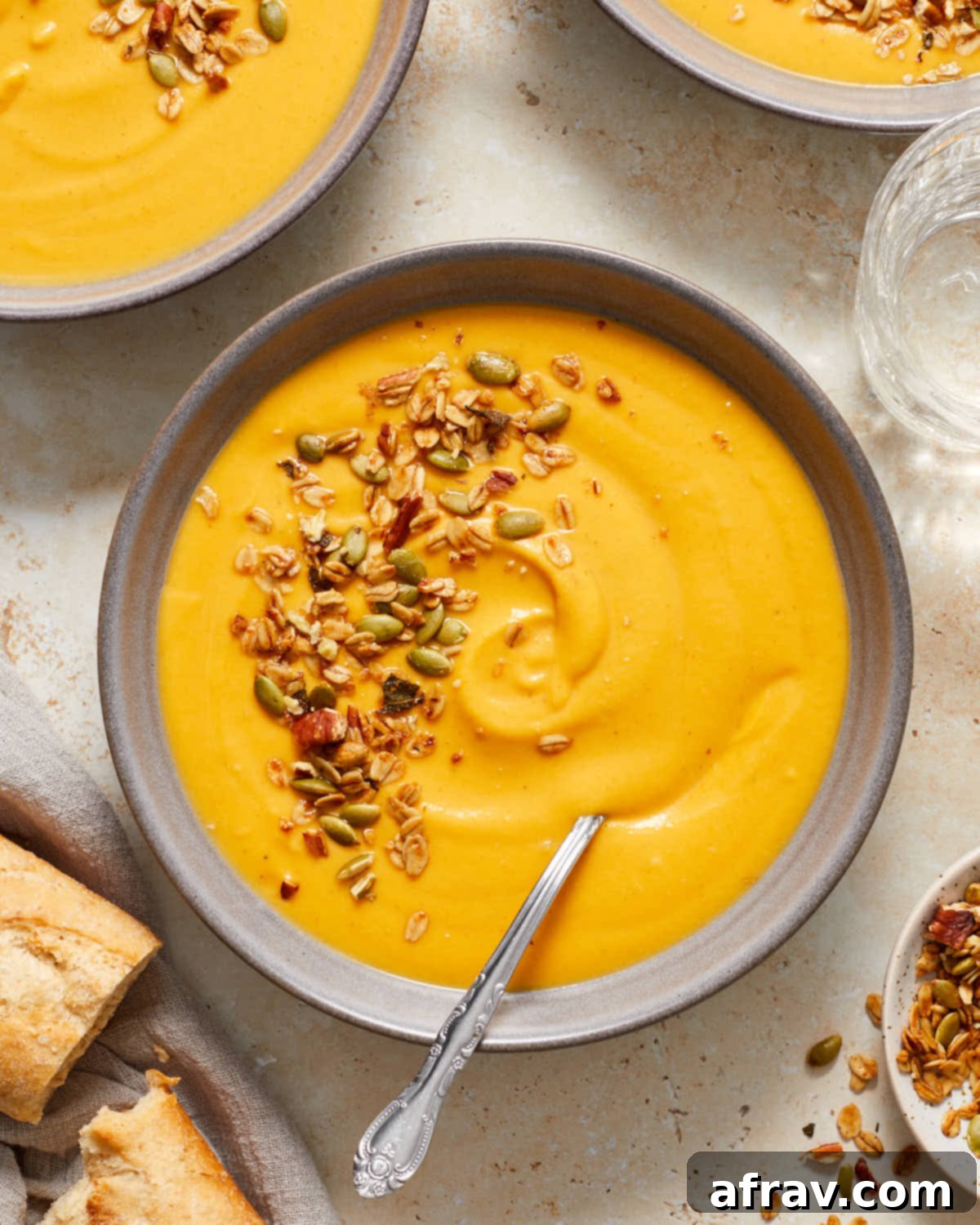 Overhead of bowls of carrot butternut squash soup.