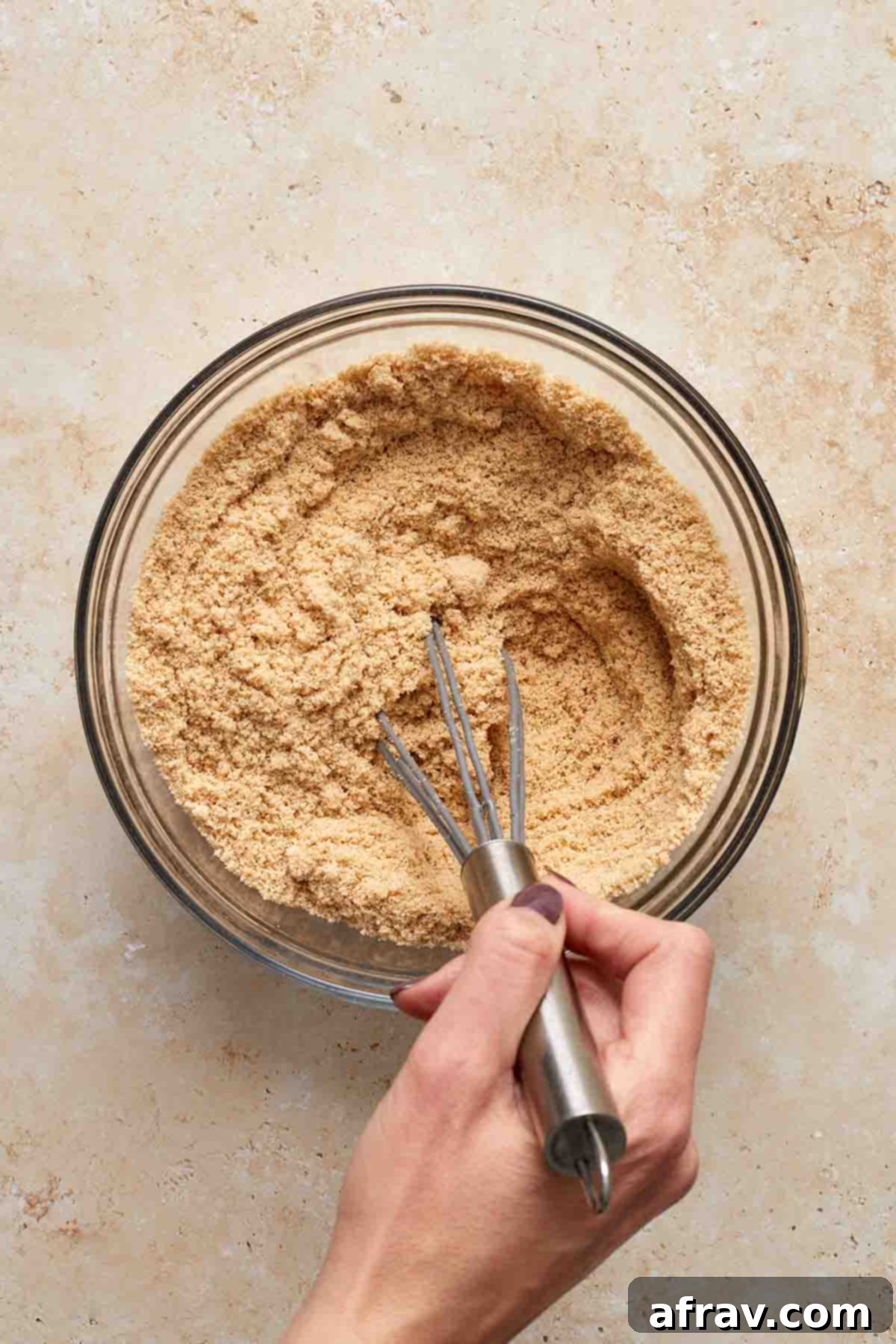 Delightful Almond Apple Cake 6 Dry ingredients being whisked together in a glass bowl.