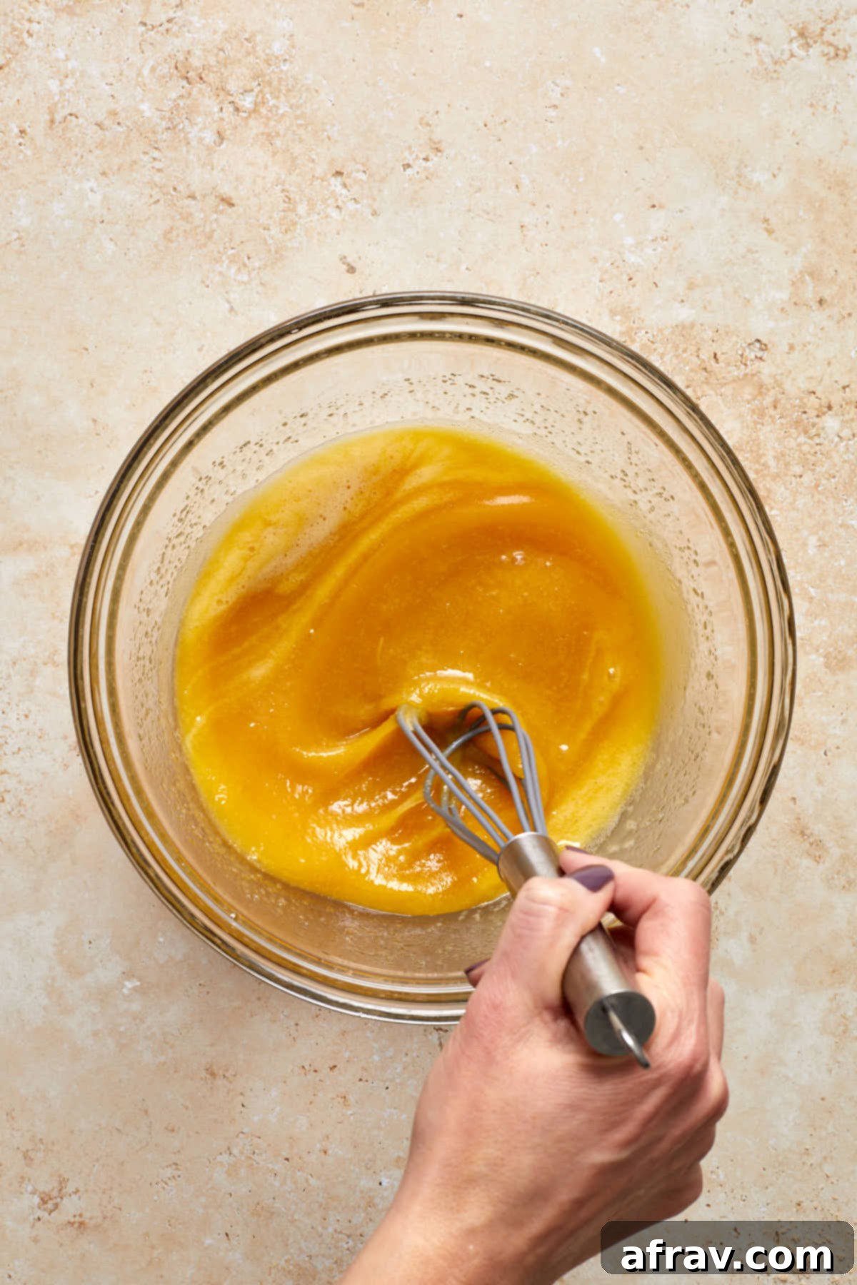 Delightful Almond Apple Cake 7 Wet ingredients being whisked together in a bowl.