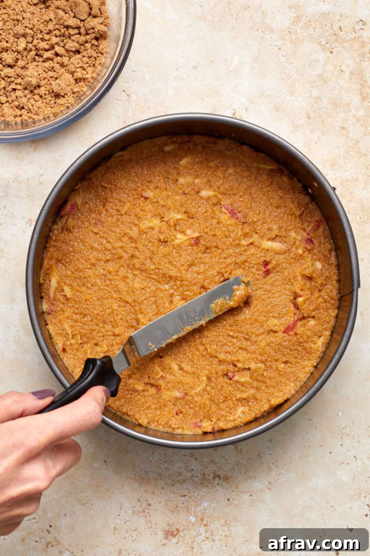Delightful Almond Apple Cake 10 Cake batter being spread out in pan with offset spatula.