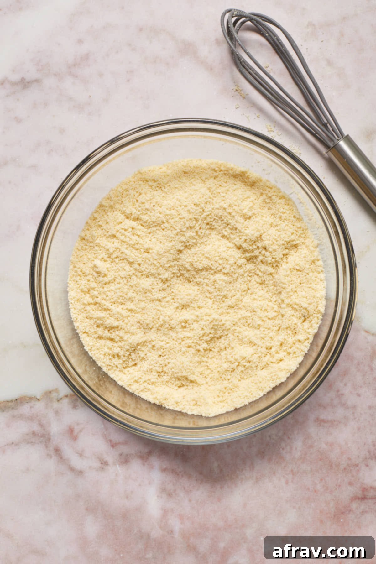 Dry ingredients, including almond flour, baking powder, and salt, whisked together in a bowl.