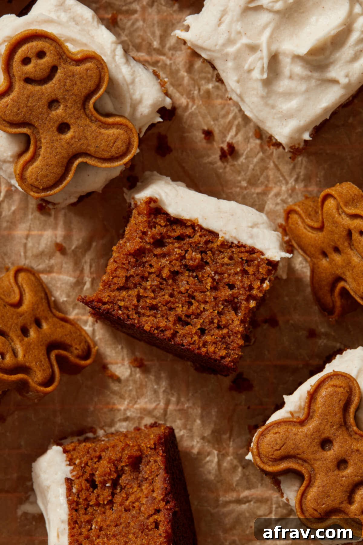 Moist Almond Flour Gingerbread Cake 11 Pieces of cake turned on their sides with gingerbread men cookies scattered around.