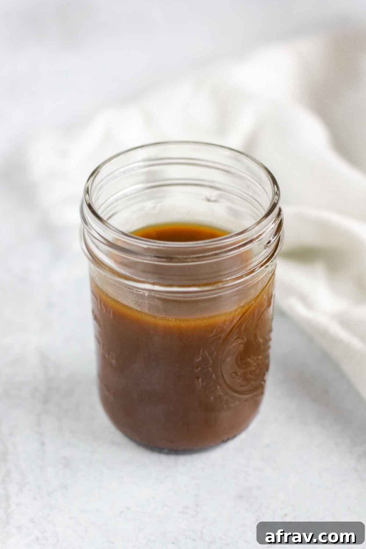Balsamic vinaigrette dressing in a mason jar, ready to be shaken and drizzled.