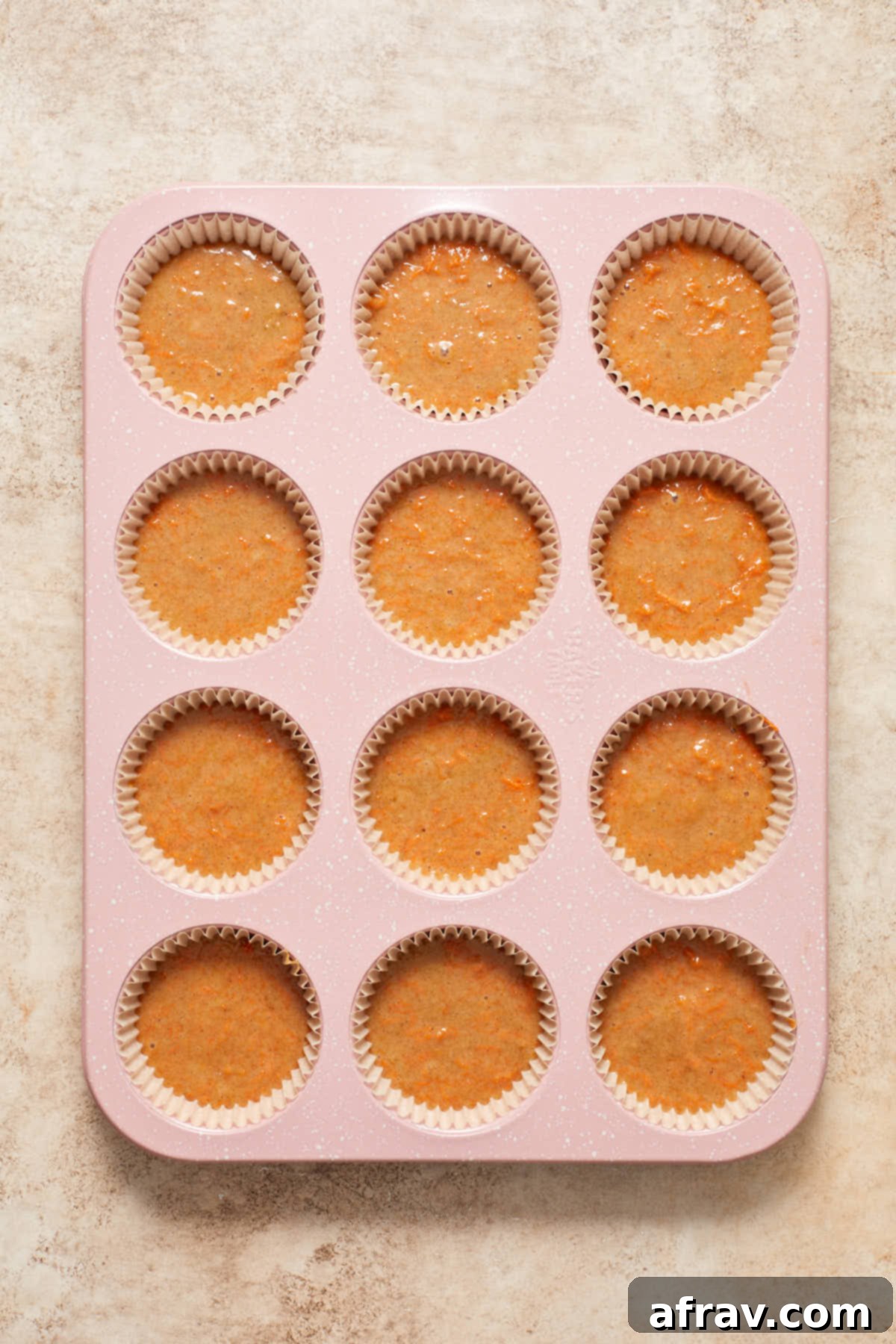 Scrumptious Gluten-Free Carrot Cake Delights 8 Cupcake batter perfectly divided into lined cupcake pan cavities, ready for baking.