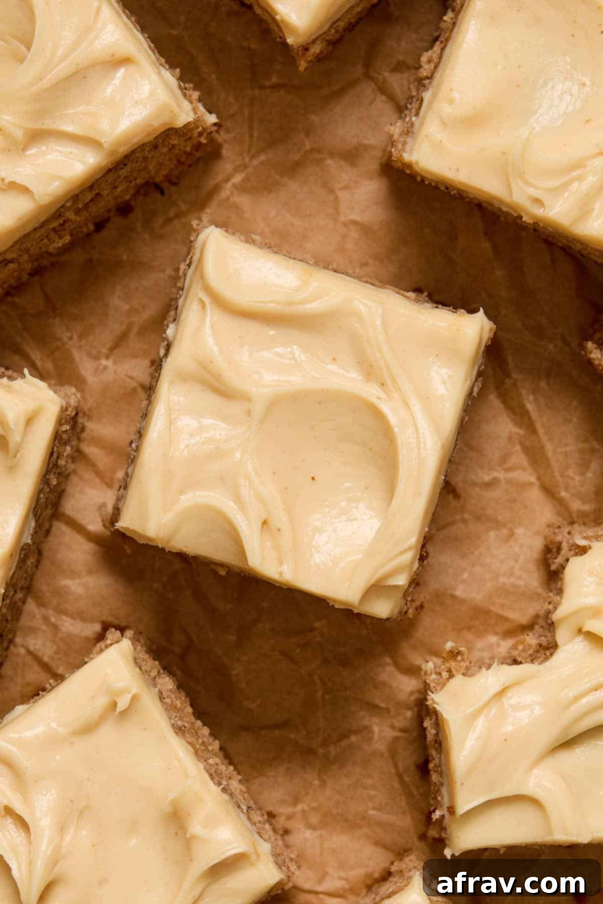 Overhead view of a slice of cake generously topped with luscious peanut butter cream cheese frosting, garnished with a sprinkle of peanuts.