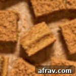 Pieces of almond flour coffee cake arranged on crumpled brown parchment paper.