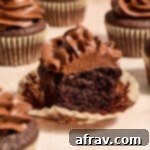 Gluten-Free Almond Flour Chocolate Cupcakes 14 Side view of an almond flour chocolate cupcake with a bite taken out, showing the rich chocolate and fluffy texture.