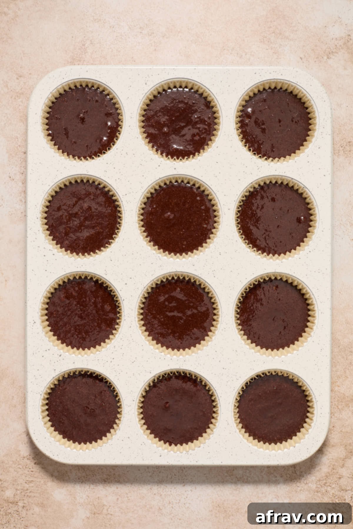 Gluten-Free Almond Flour Chocolate Cupcakes 9 Chocolate cupcake batter divided into a muffin pan lined with parchment cupcake liners.