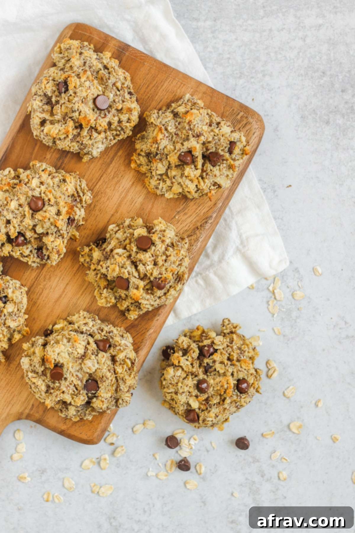 Breakfast oatmeal cookies on a wood cutting board, showcasing their wholesome texture.