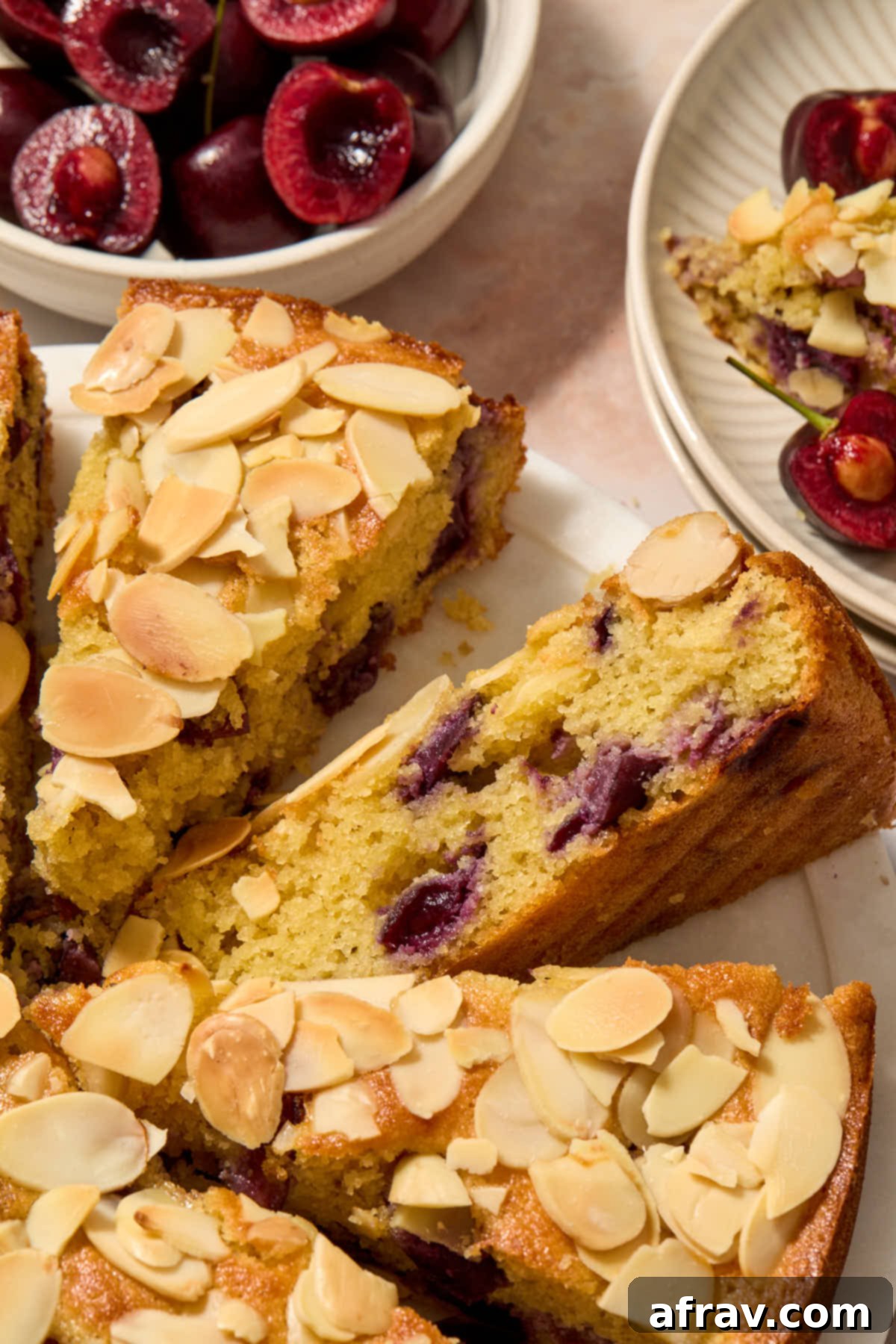 Slice of cherry almond cake turned on its side.