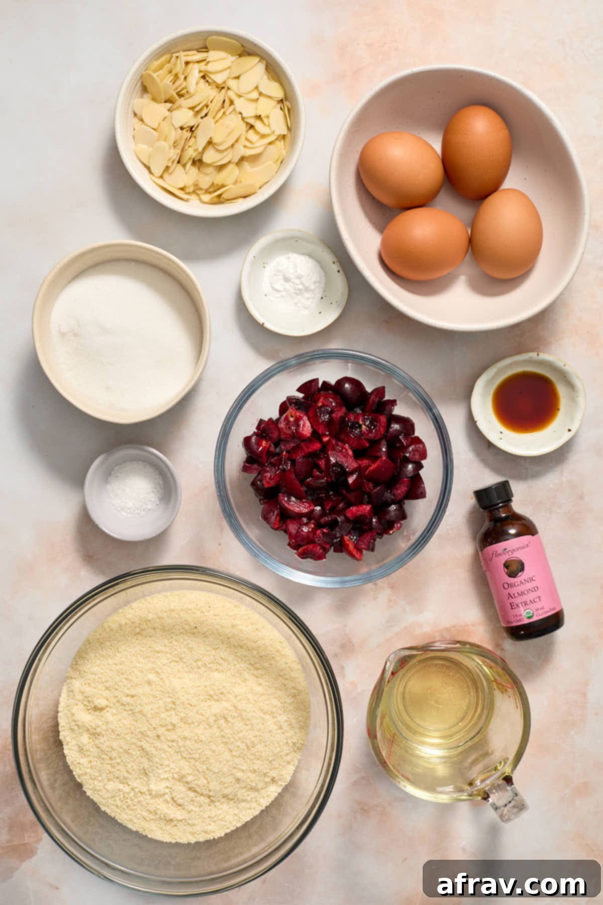 Ingredients to make a cherry almond cake arranged individually.