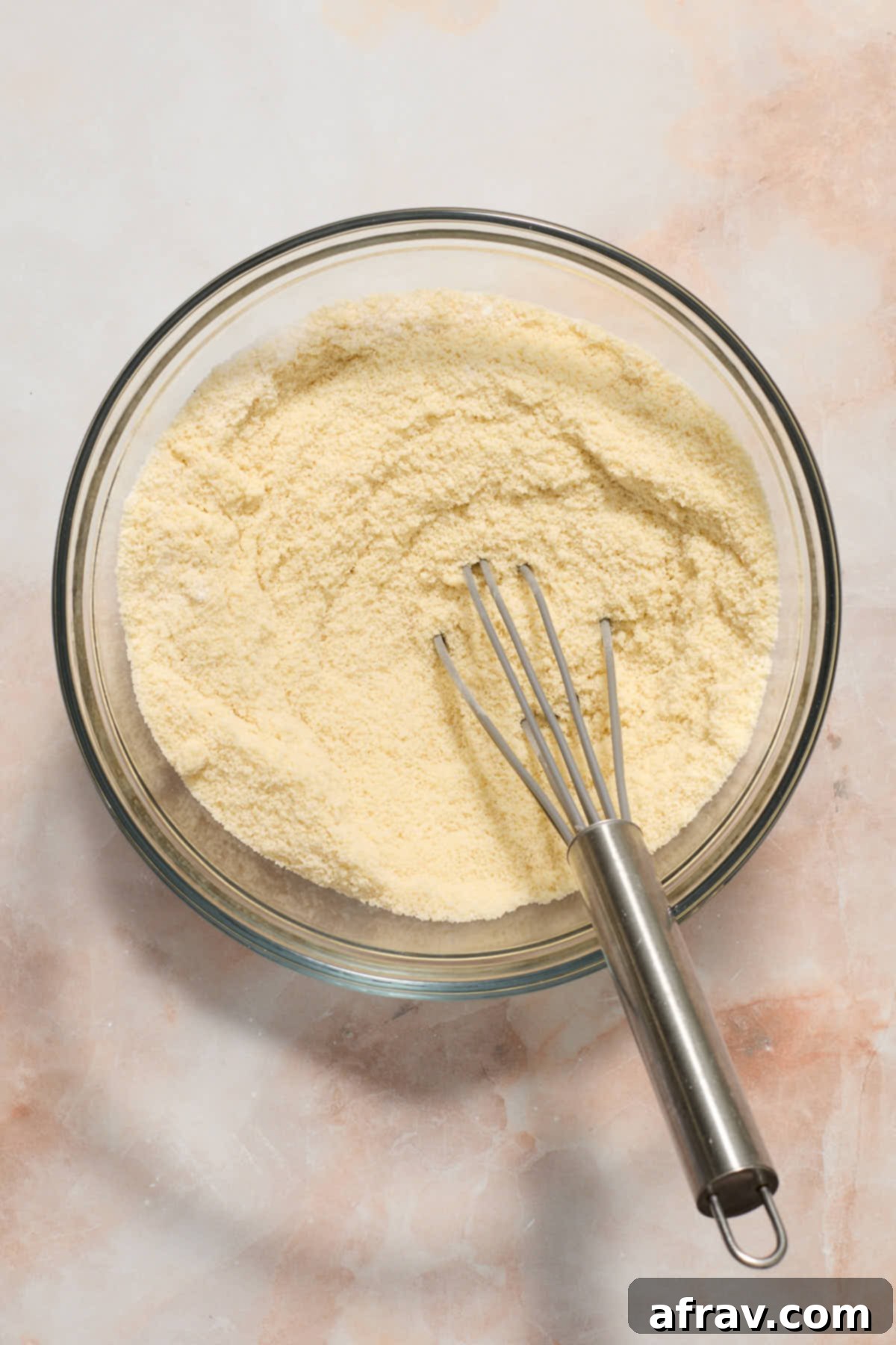 Dry cake ingredients whisked together in a bowl.
