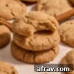 Stack of almond flour snickerdoodles with a bite taken out of the top one.