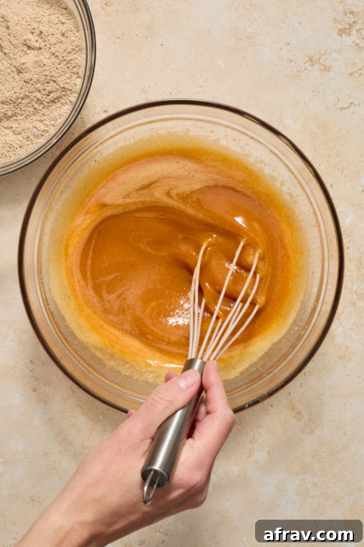 Spiced Almond Flour Pumpkin Cake 7 Wet mixture, including pumpkin, maple syrup, oil, and vanilla, whisked into the egg and sugar mixture.