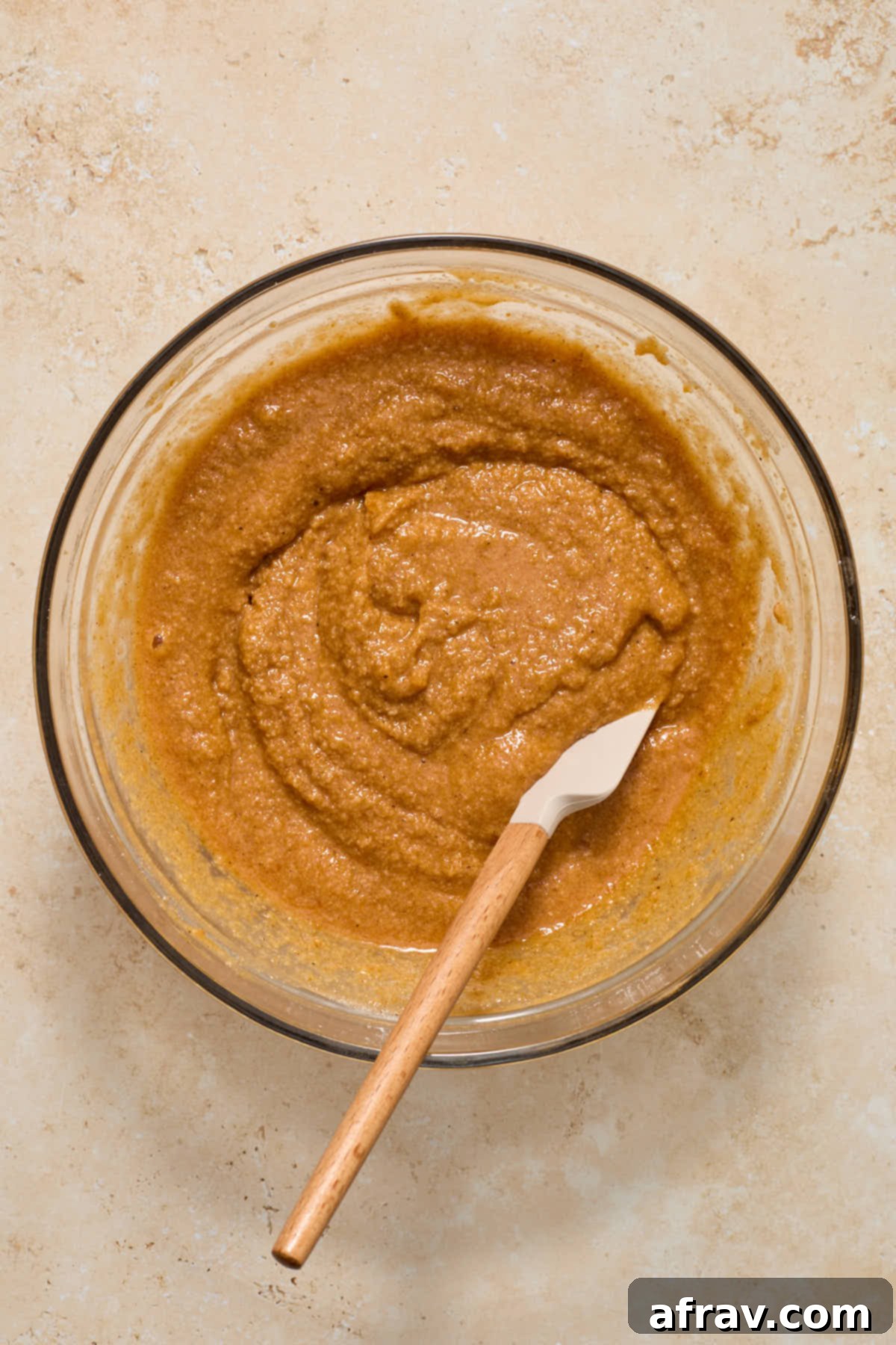 Spiced Almond Flour Pumpkin Cake 8 Cake batter combined gently with a spatula in a glass bowl.