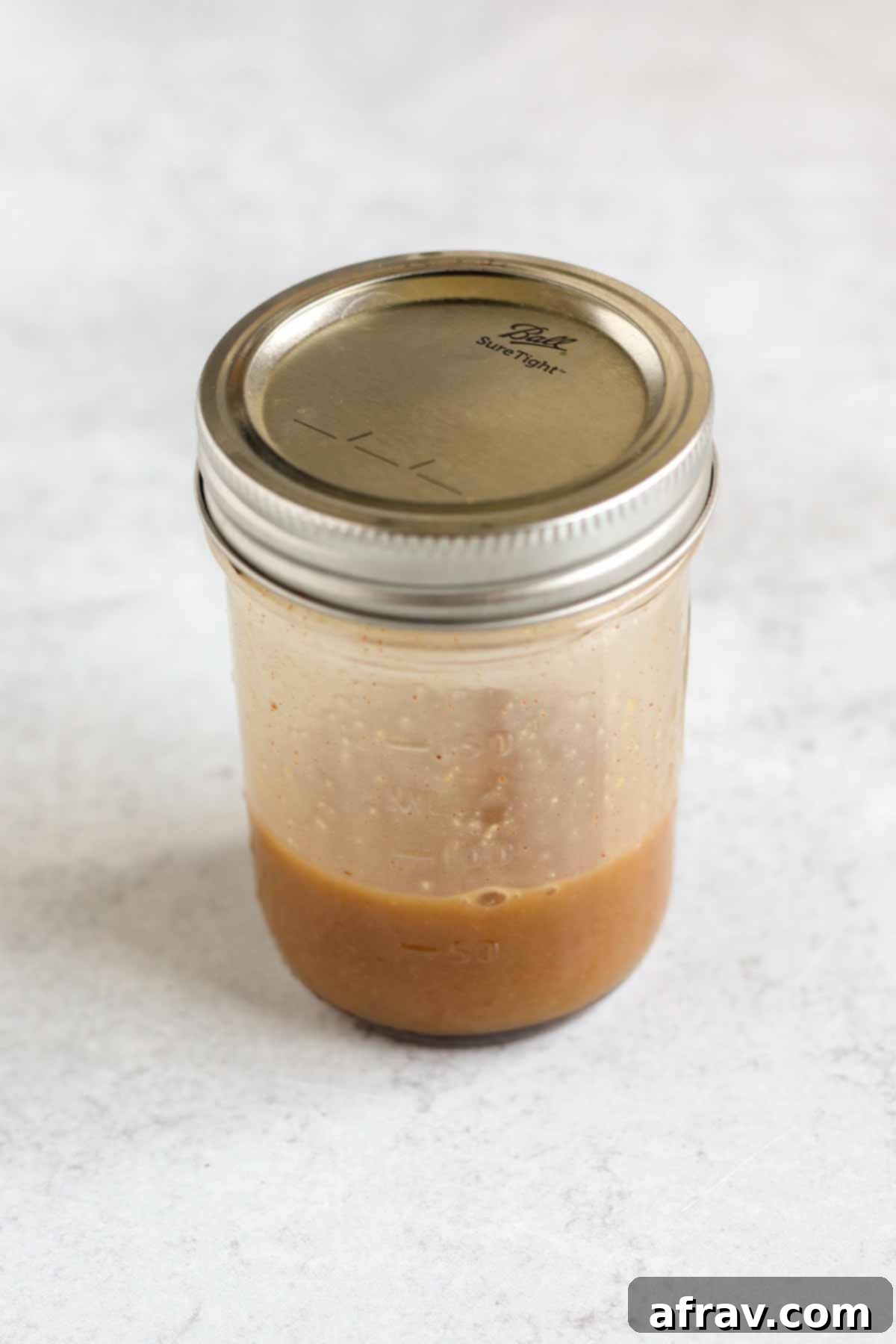 Sheet Pan Maple Dijon Salmon Dinner 5 Covered mason jar with maple Dijon vinaigrette.