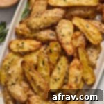 Air fryer fingerling potatoes served on a platter and topped with fresh rosemary.