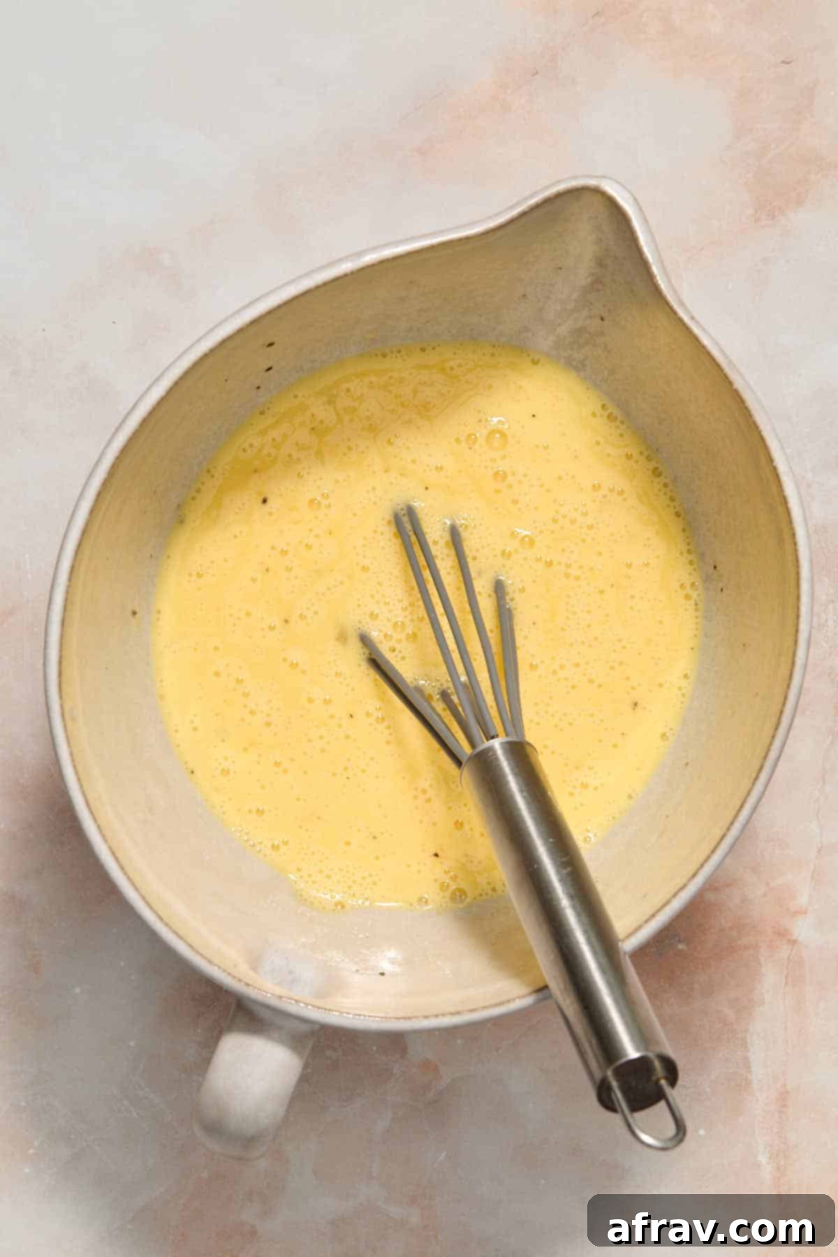 Velvety Air Fryer Frittata with Savory Spinach Bacon and Cheese 4 Egg mixture whisked together in a bowl, showing the creamy consistency.