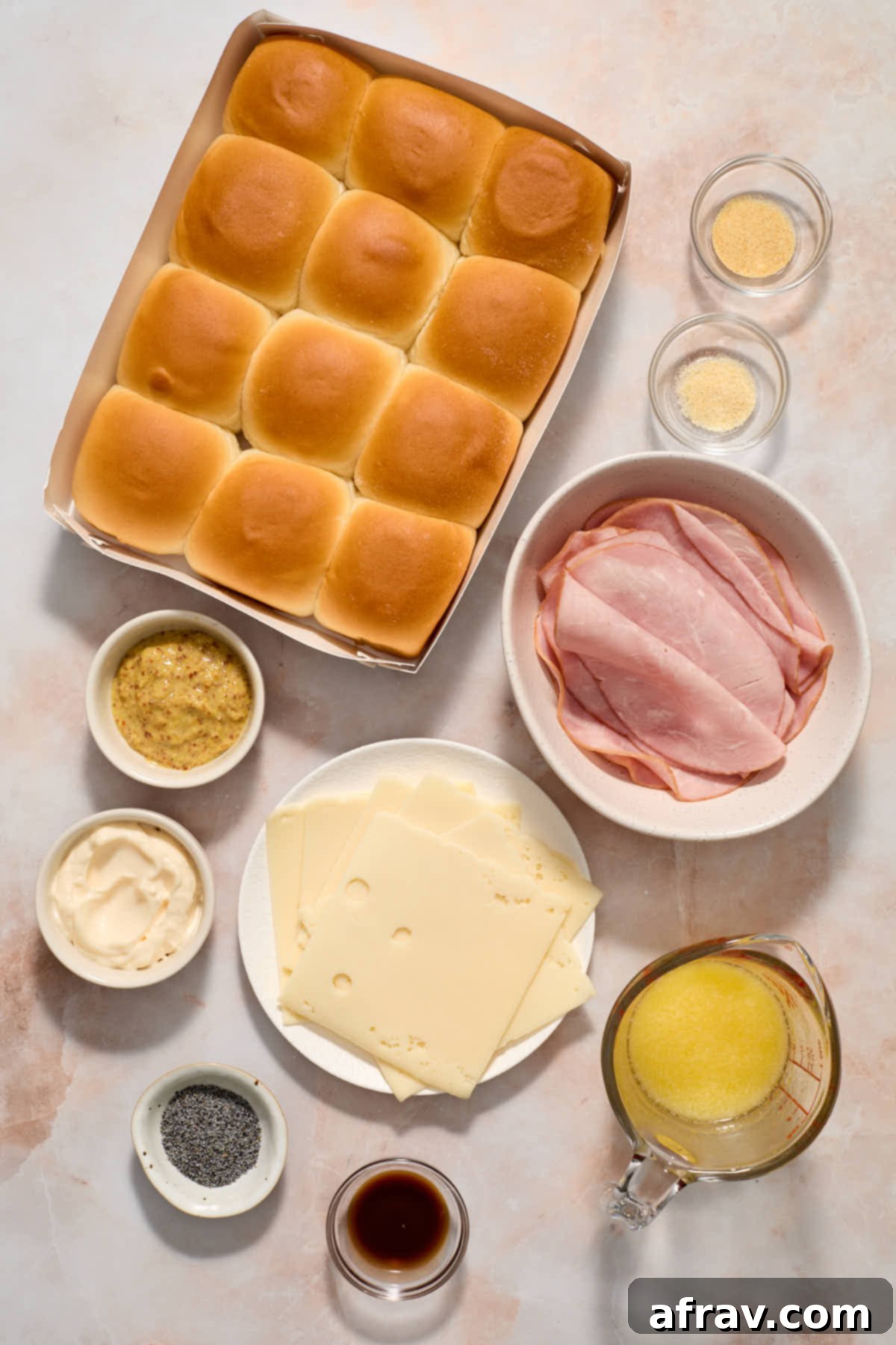 Ingredients to make air fryer ham and cheese sliders arranged on a work surface.