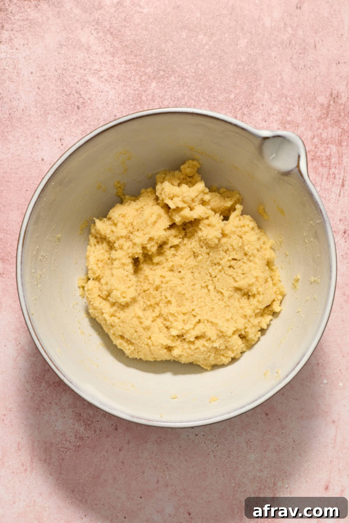 Cookie dough fully mixed together, showing a soft, cohesive texture in the mixing bowl.