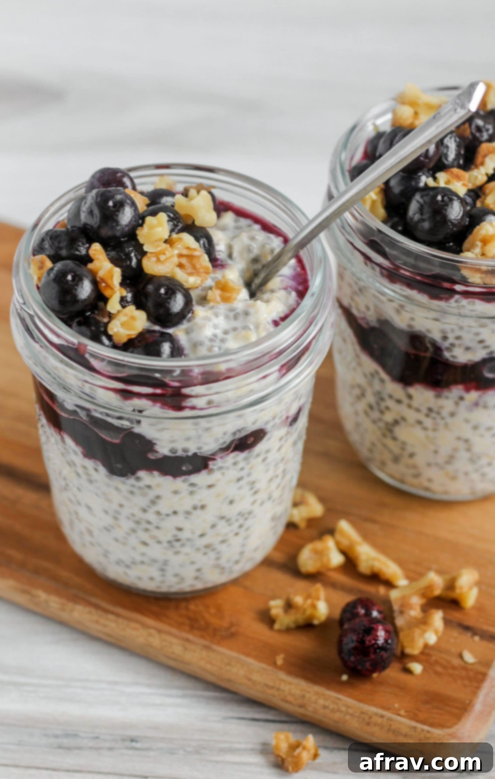 Overnight Blueberry Chia Oats 3 overnight oats in mason jar topped with blueberries and walnuts