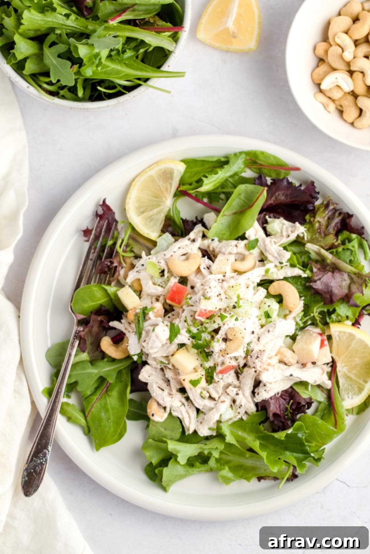Chicken salad on a bed of spring mix, showcasing the fresh ingredients.
