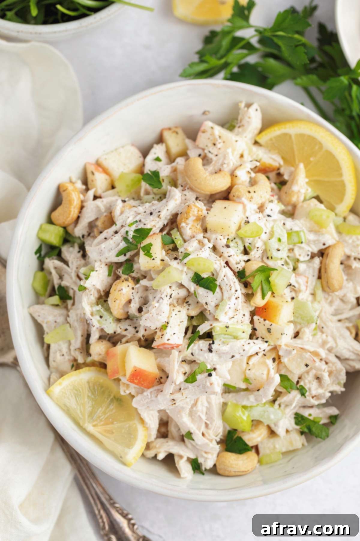 Dairy-free chicken salad with apples in a white bowl, ready to serve.