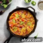 Golden Sweet Potato Frittata with Crispy Turkey Bacon 2 Sweet Potato Frittata with turkey bacon in a cast iron skillet.