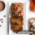 Dark Chocolate Coconut Whole Wheat Pumpkin Bread 2 Overhead view of a freshly baked Whole Wheat Pumpkin Bread, cut into perfect slices and artfully arranged on a white plate, showcasing the delicious texture and chocolate.
